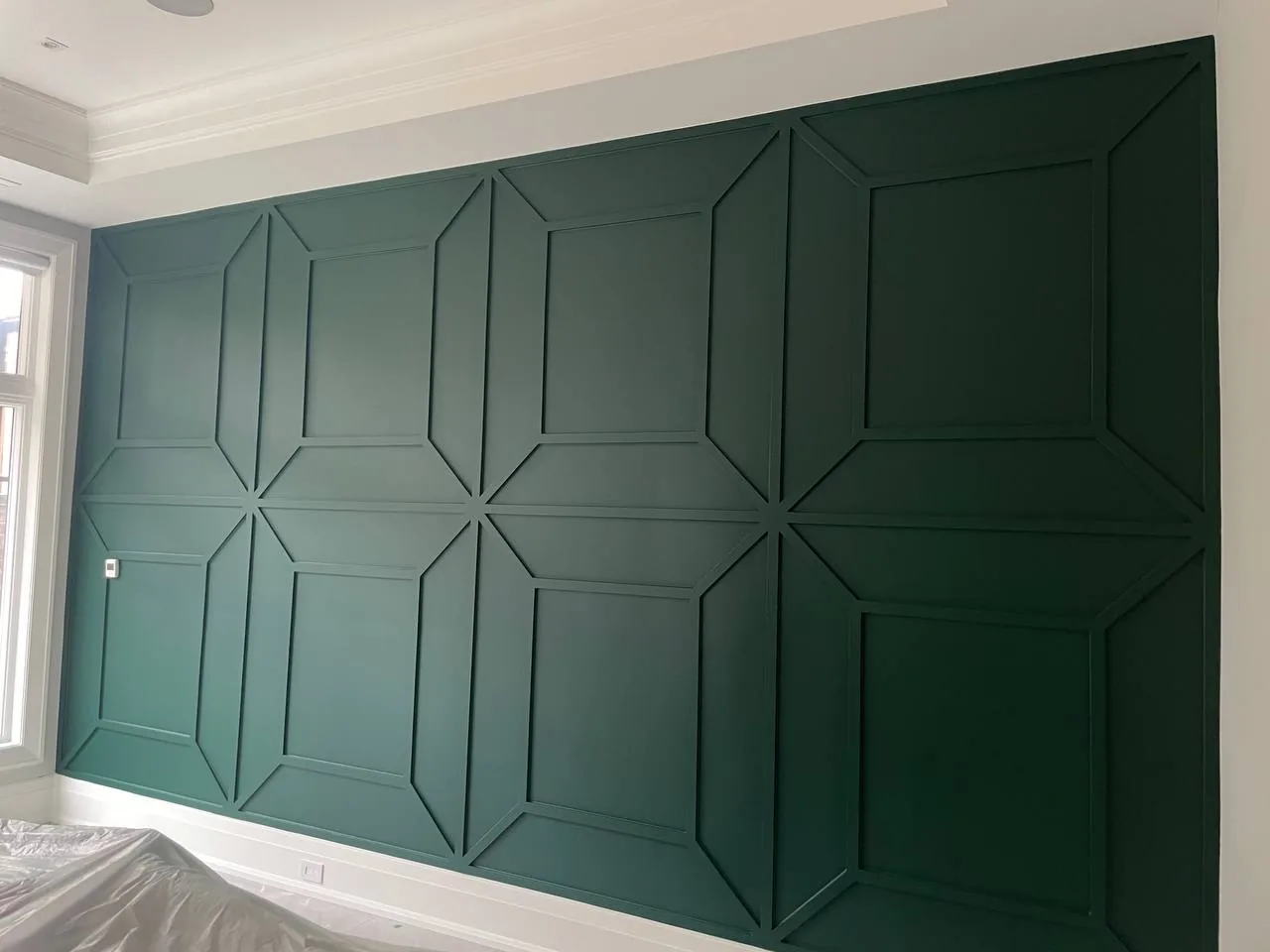 Custom green accent wall with trim